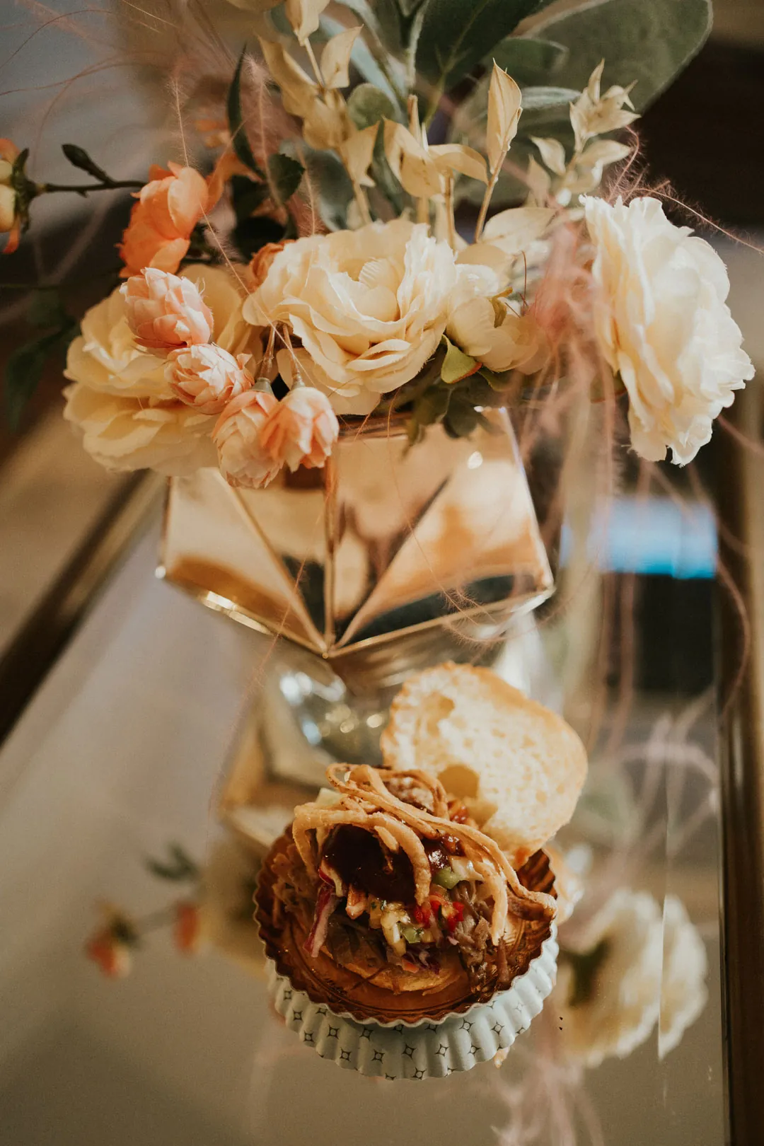 Floral centerpiece beside a small appetizer display