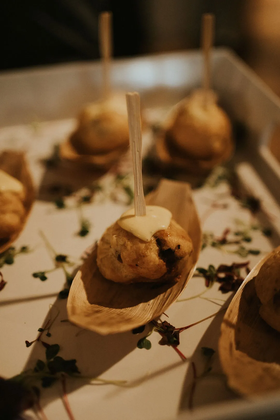 Appetizers presented on individual wooden spoons