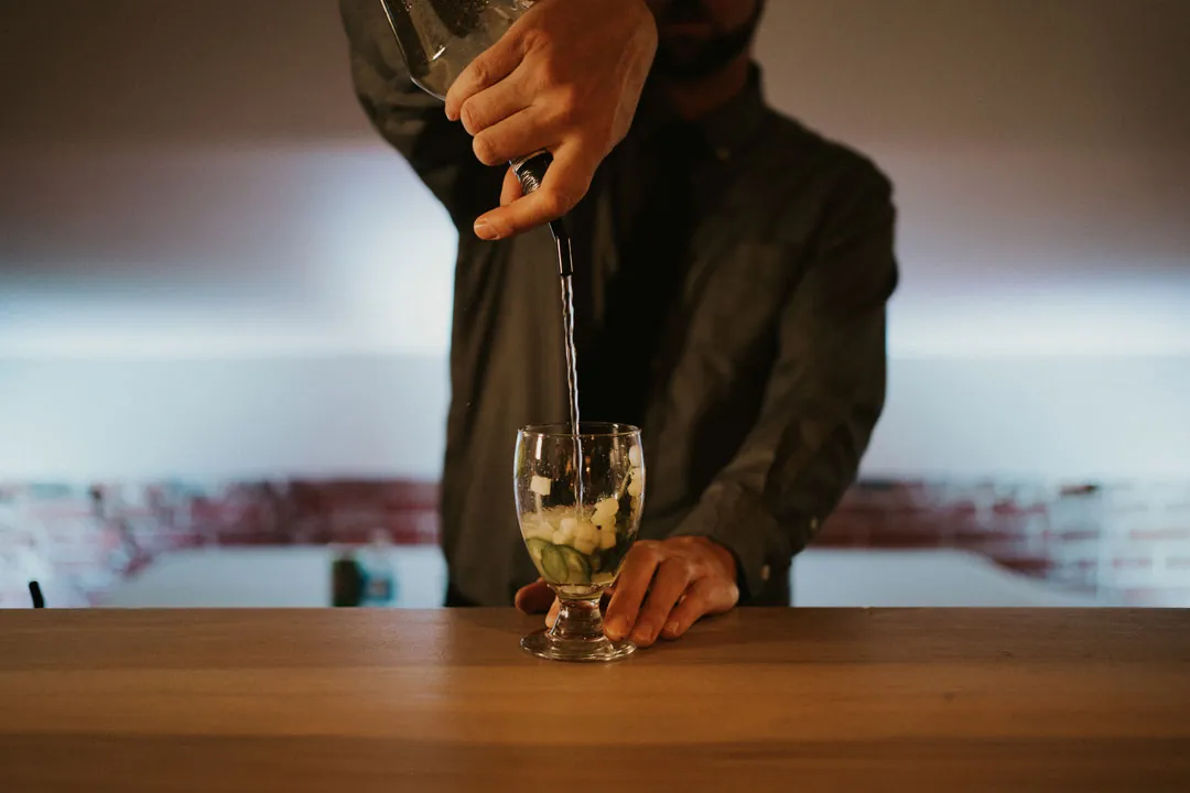 Bartender stirring a drink in a glass