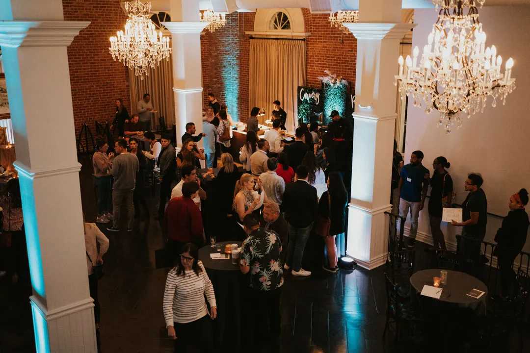 Guests gathering in the chandelier-lit ballroom