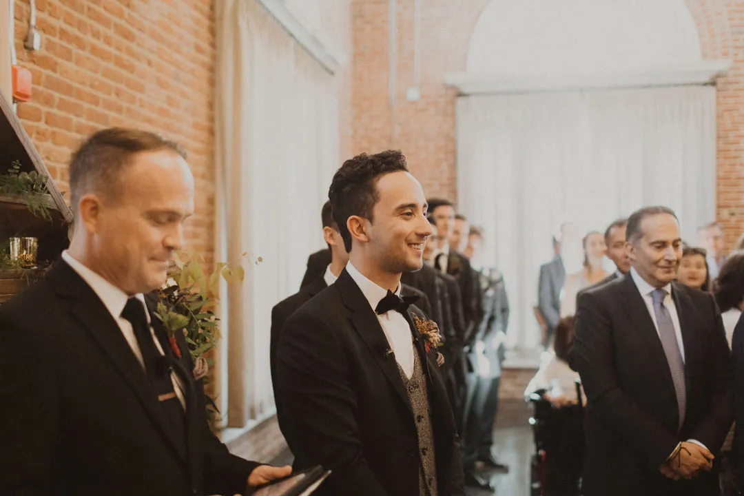Groom and groomsmen standing together during the ceremony