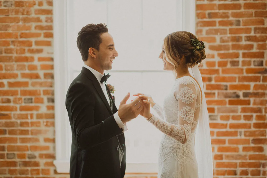 Couple holding hands and smiling in a bright room