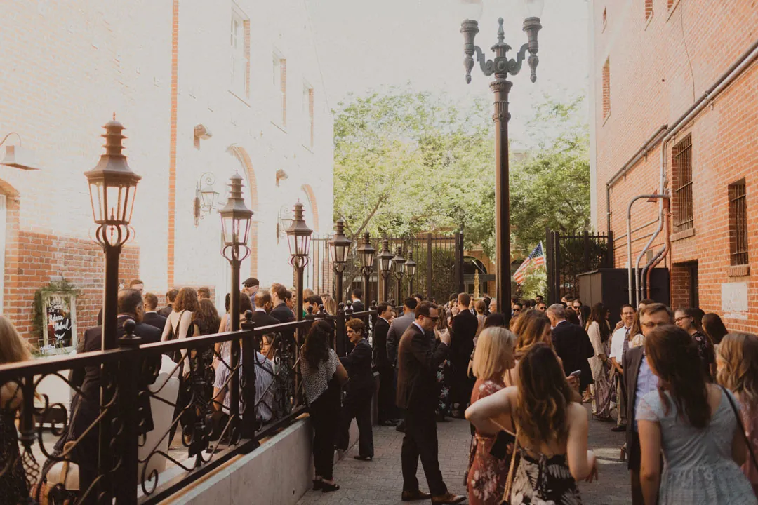 Wedding guests gathered on an outdoor terrace