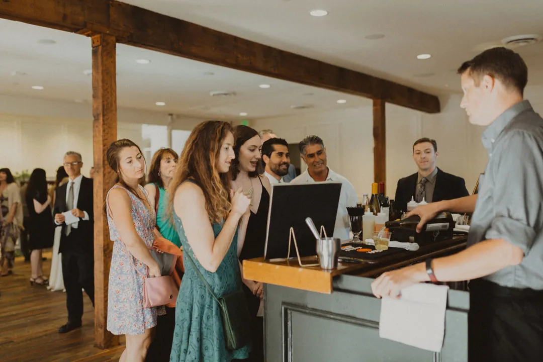 Guests ordering drinks from a bar
