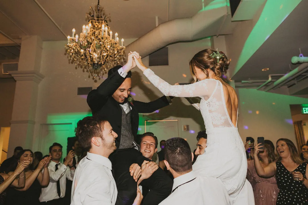 Bride lifted above the crowd on the dance floor