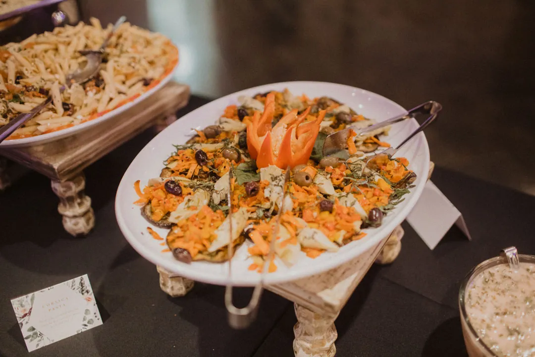 Platters of prepared food displayed on a buffet