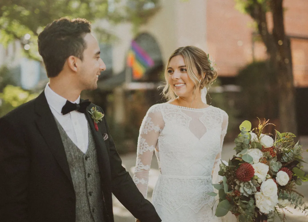 Couple smiling at one another outdoors