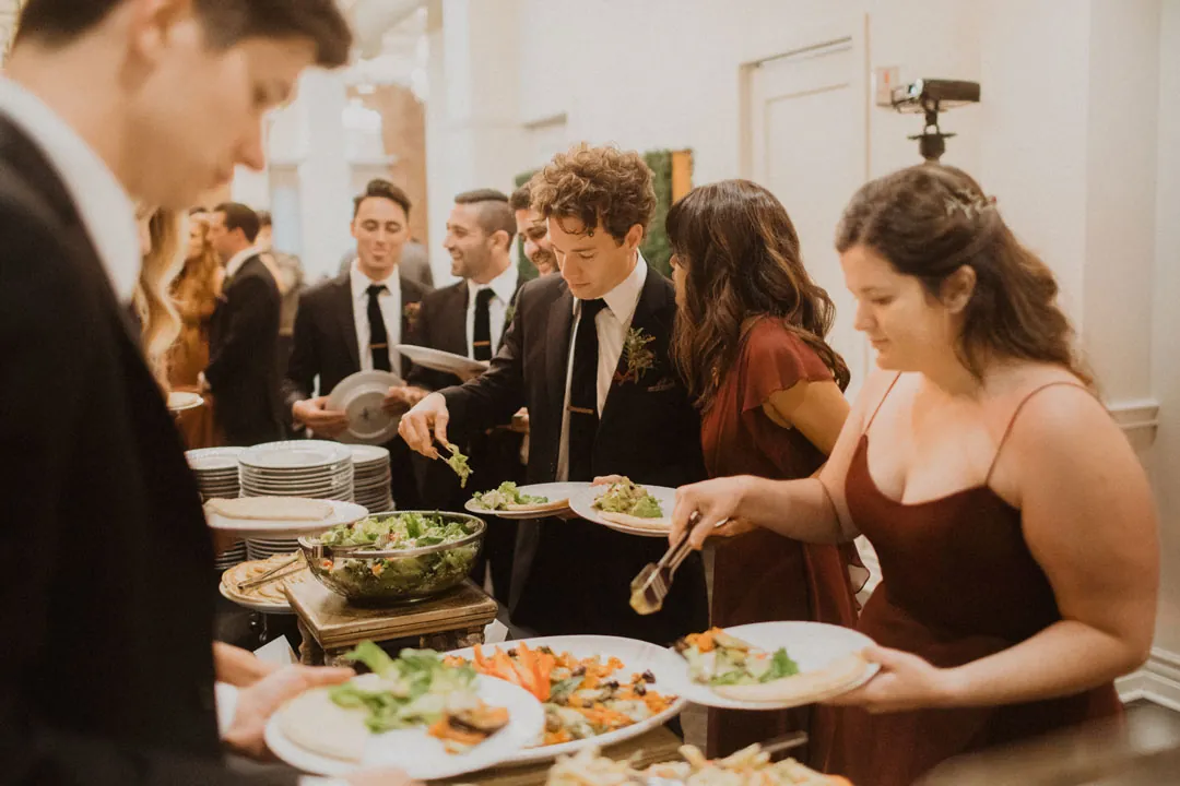 Wedding guests serving themselves from a buffet