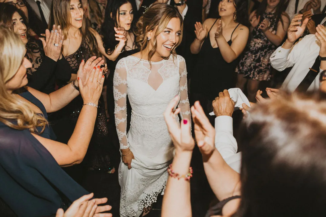 Bride dancing among celebrating guests