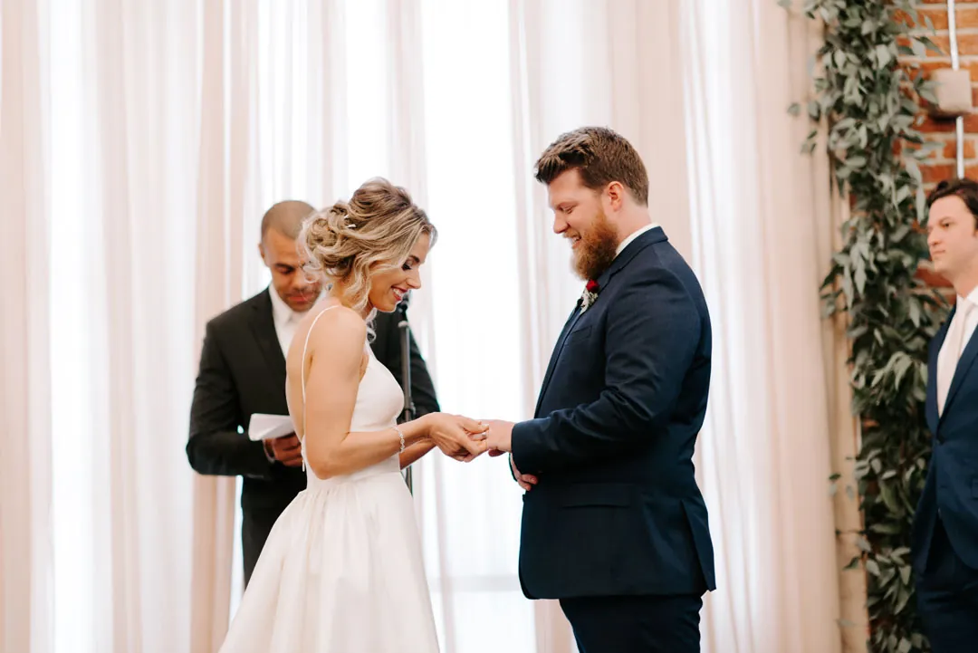 Bride and groom exchanging rings
