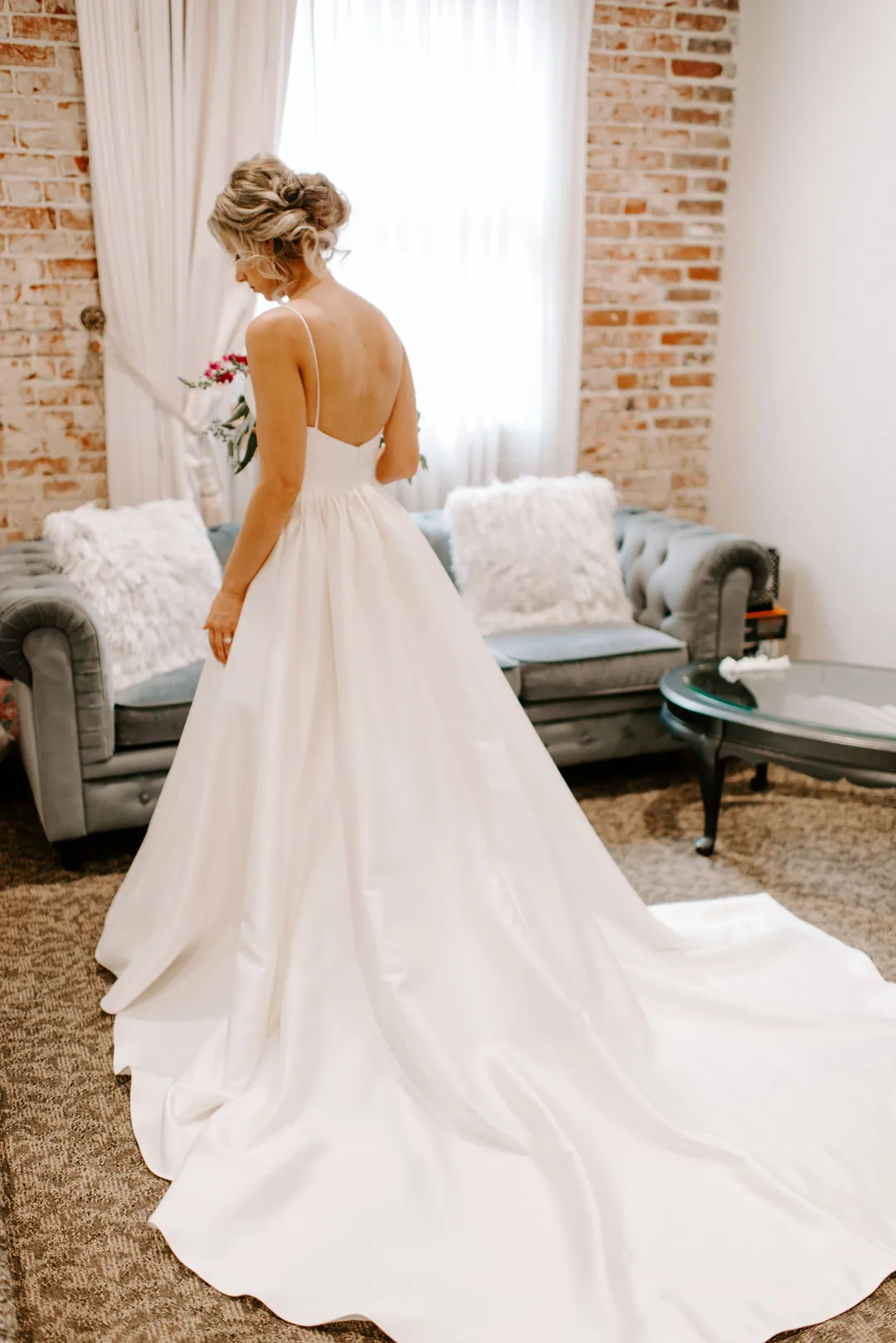 Bride showing the flowing train of her gown