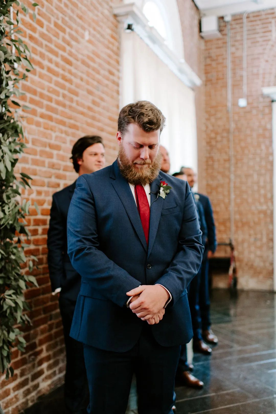 Groom standing at the front of the wedding ceremony