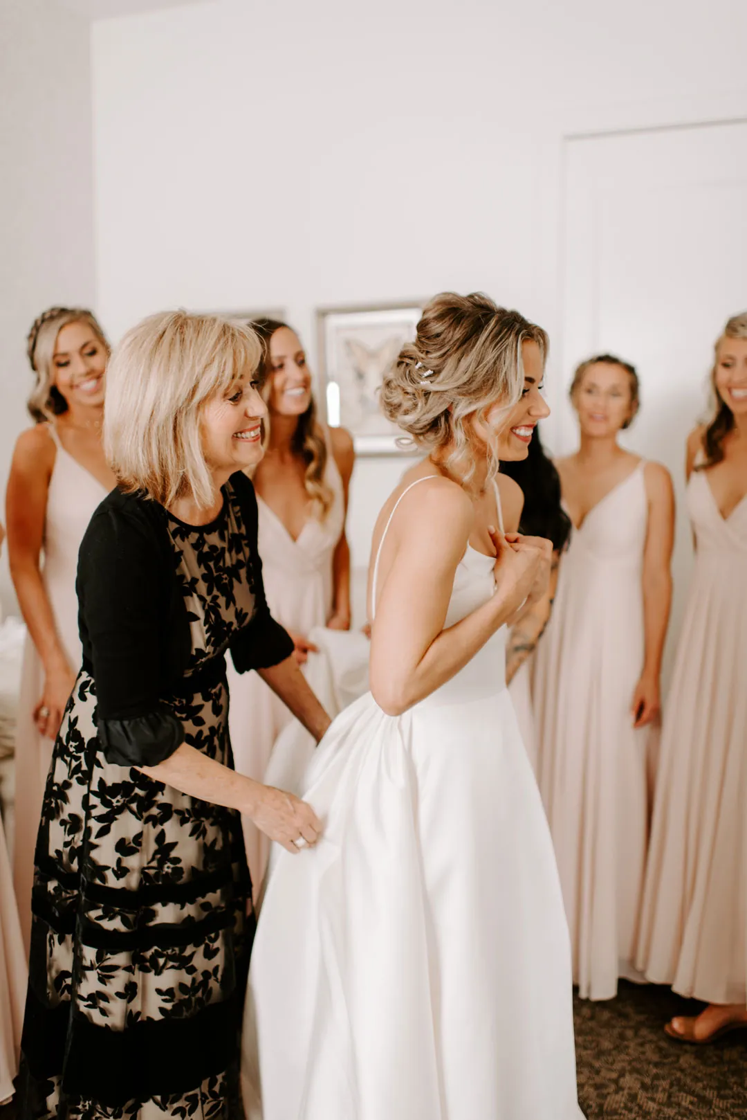 Bride getting ready with attendants in a lounge