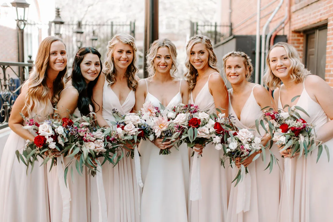 Bride and bridesmaids holding colorful bouquets