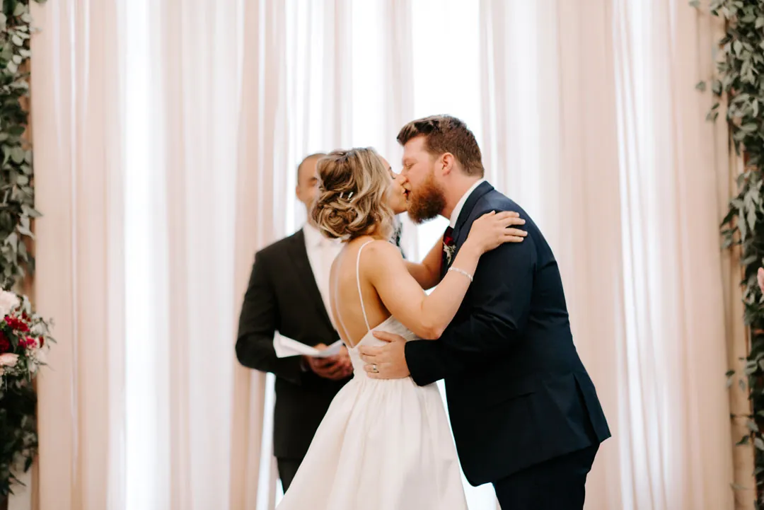 Bride and groom kissing during their ceremony