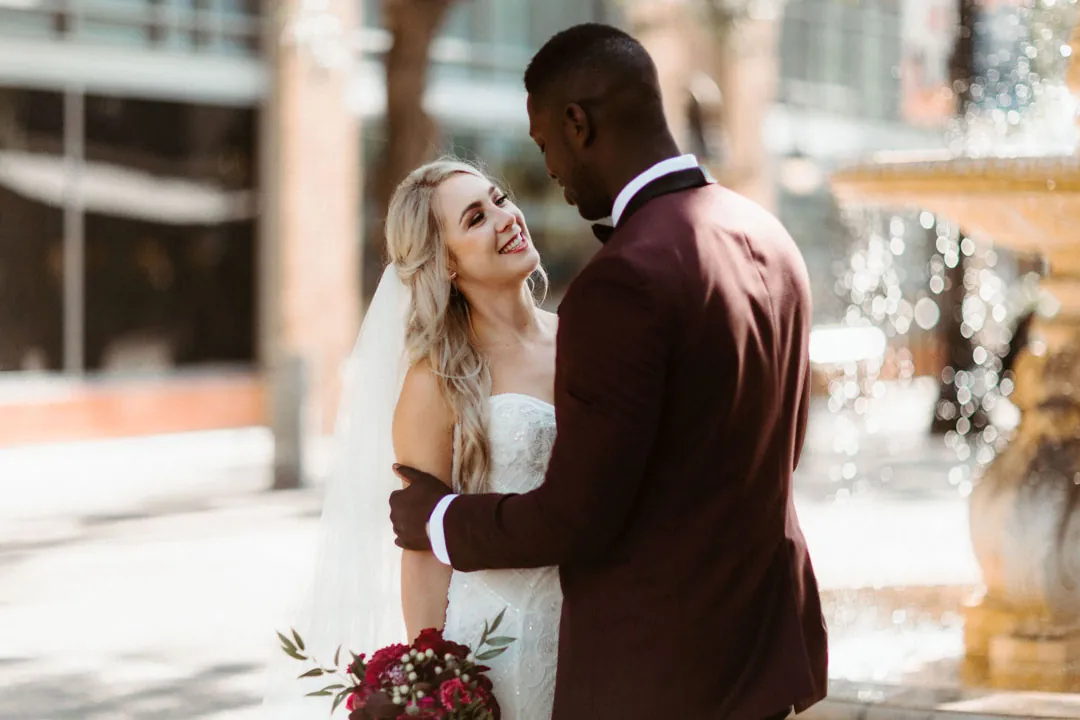 Bride and groom smiling together outdoors