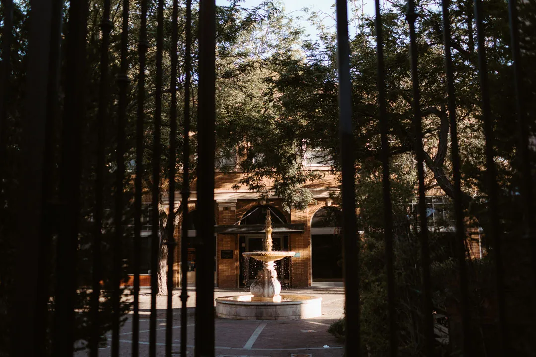 Fountain viewed through the venue's iron gate