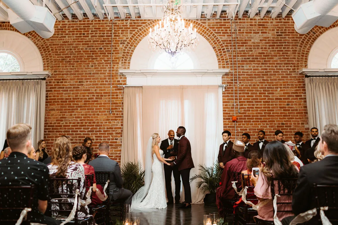 Guests watching a wedding ceremony in the ballroom