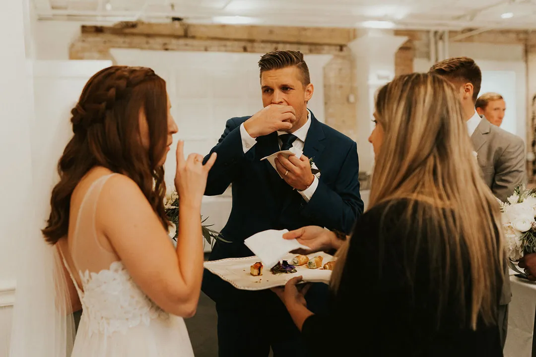 Newlyweds eat with guests during the reception.