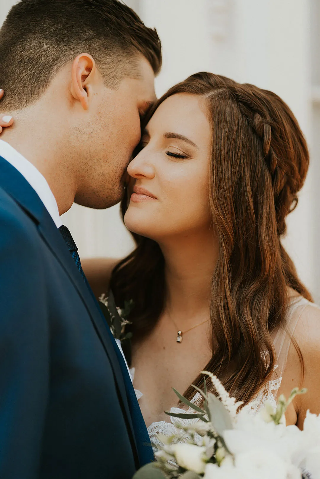 Couple kiss with their eyes closed.