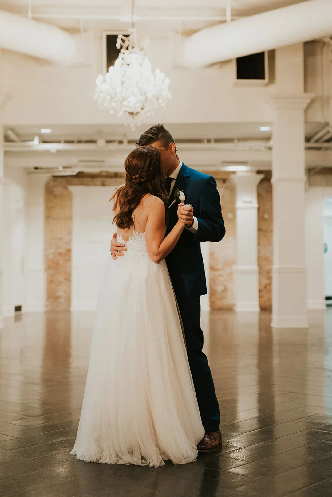 Couple embrace during their first dance.