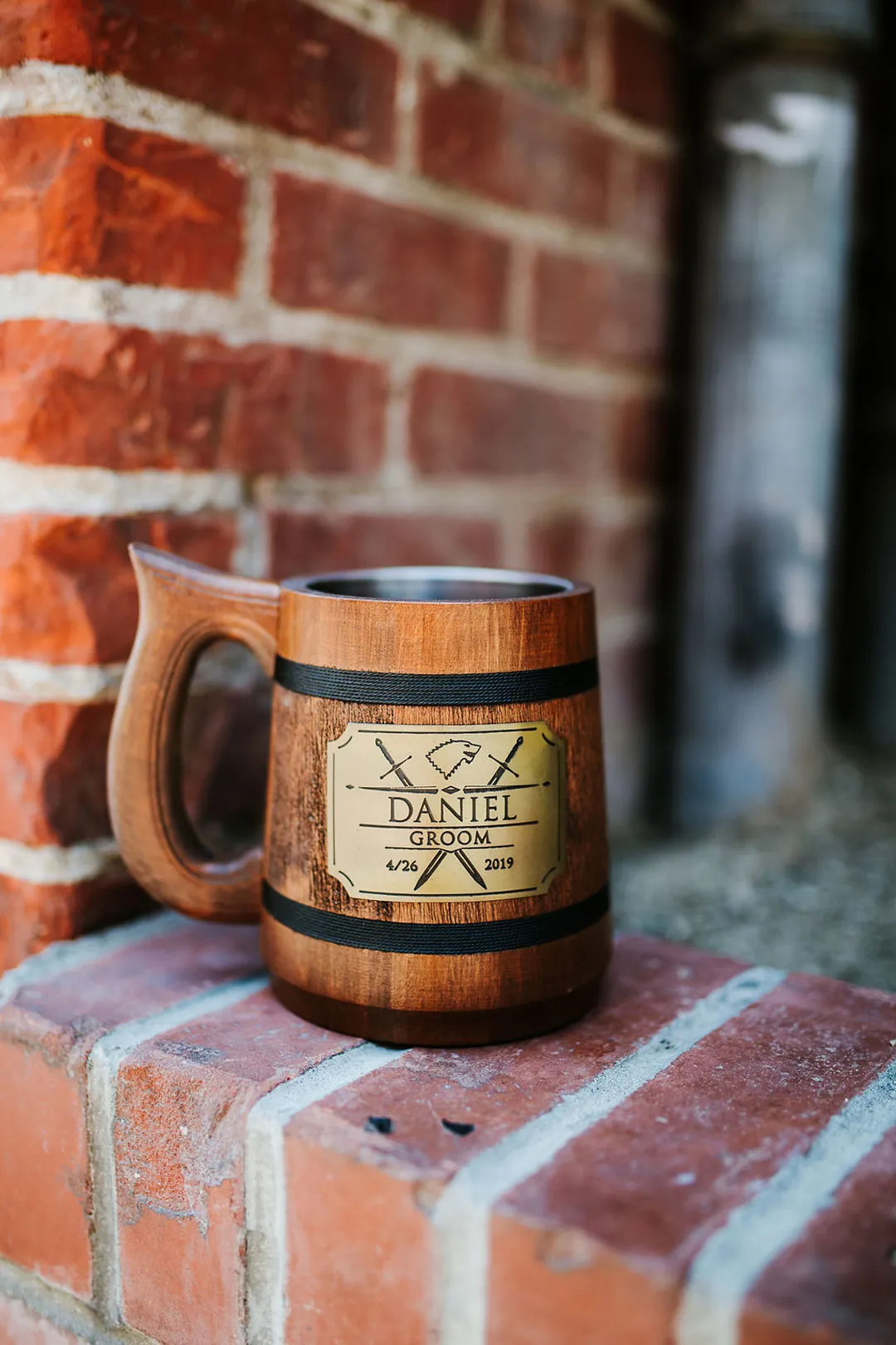 Wooden mug on a brick window ledge.
