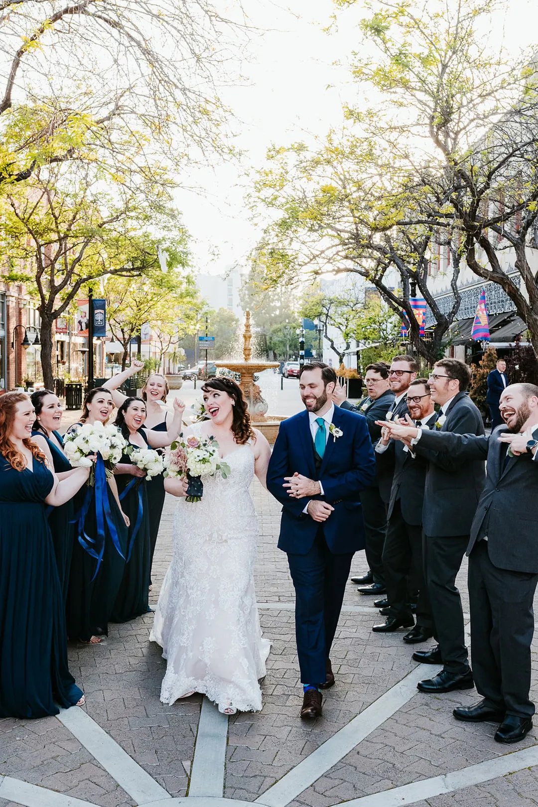 Newlyweds leave between guests gathered outdoors.