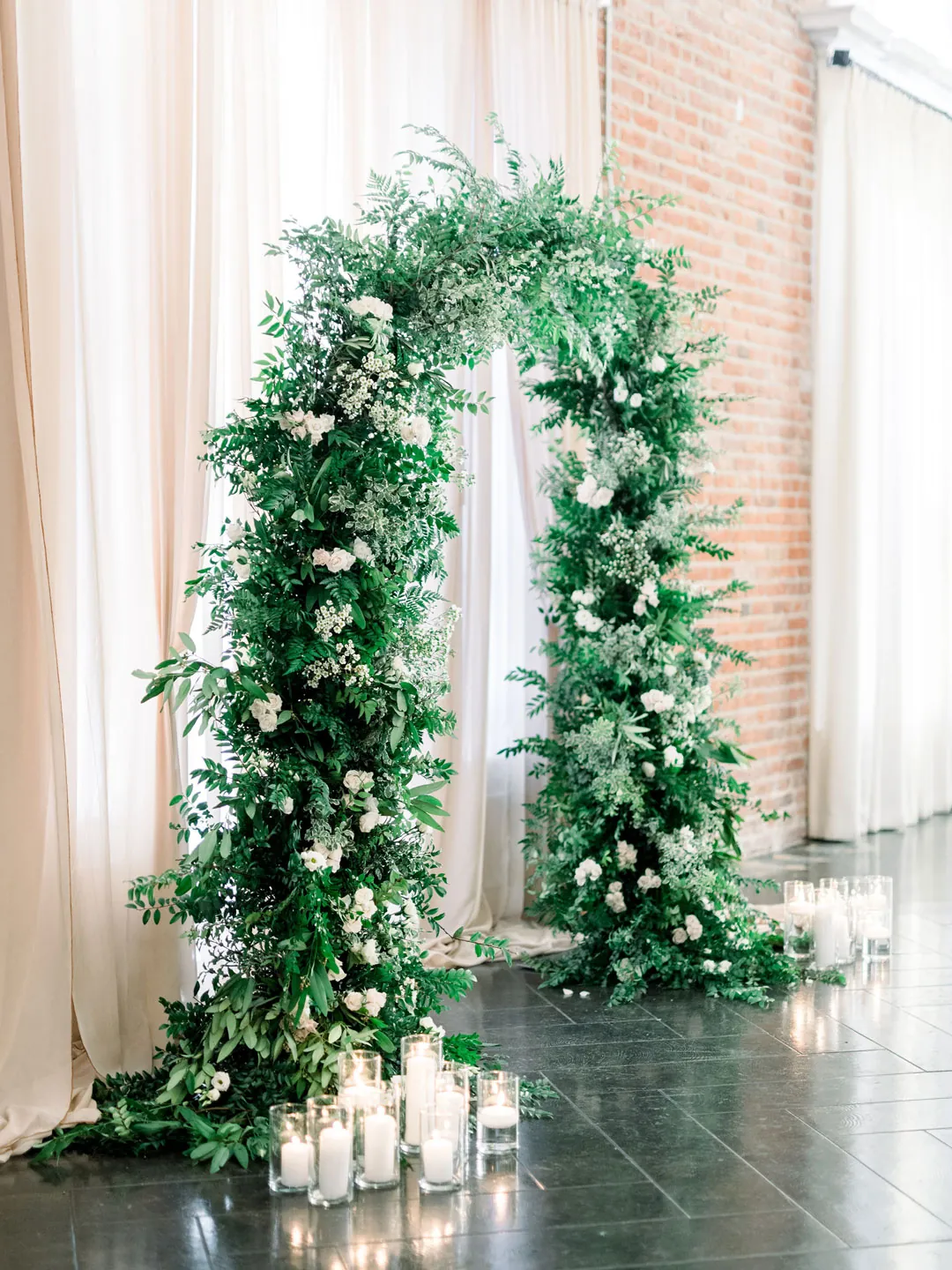 Circular greenery ceremony arch in the ballroom