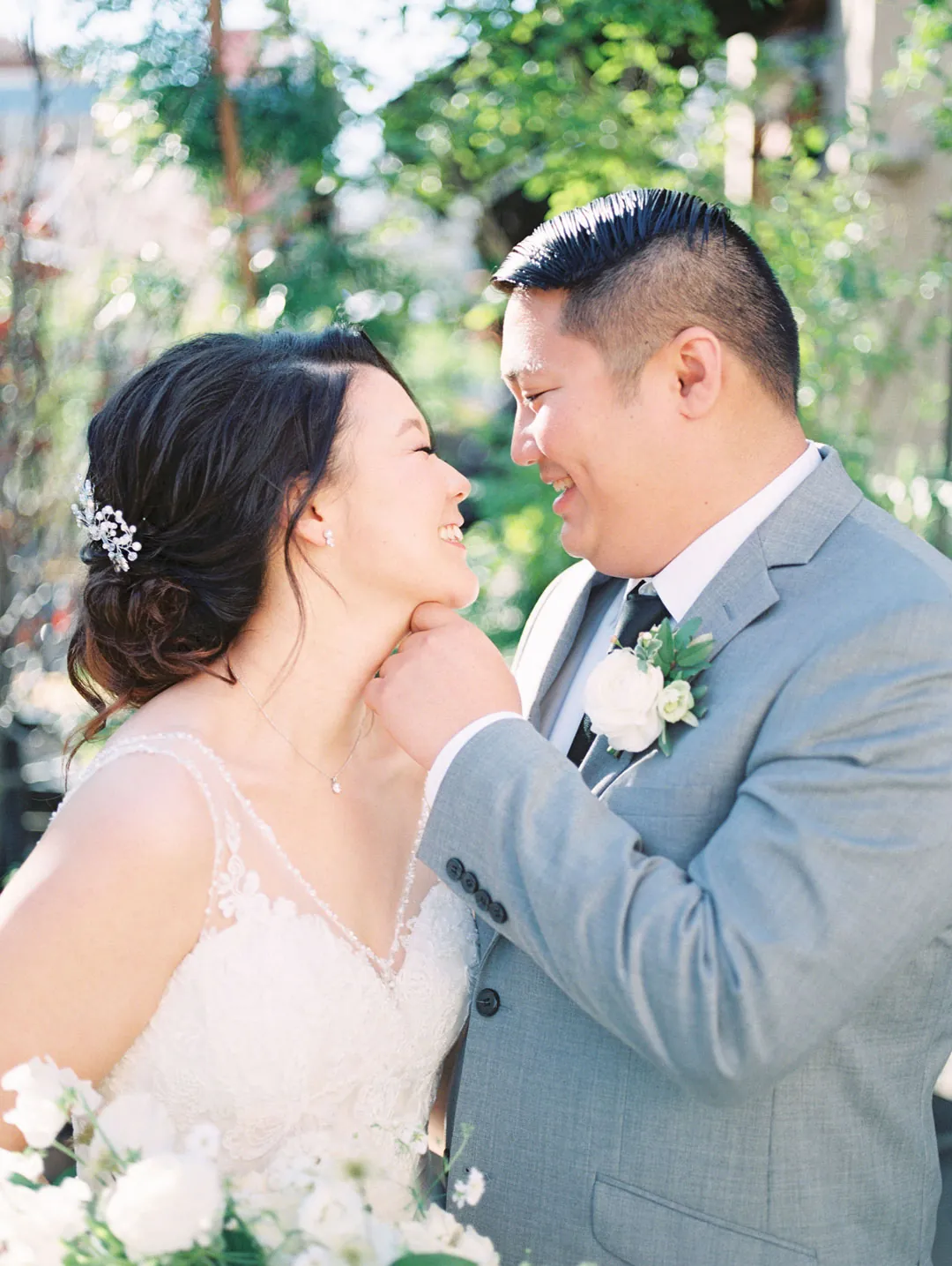 Groom touching the bride's chin as they smile