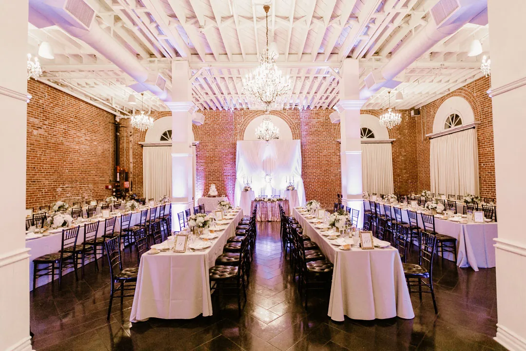 Reception tables under soft purple lighting