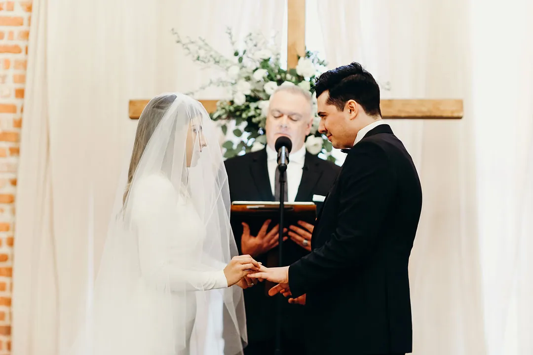 Couple exchanging vows in front of an officiant