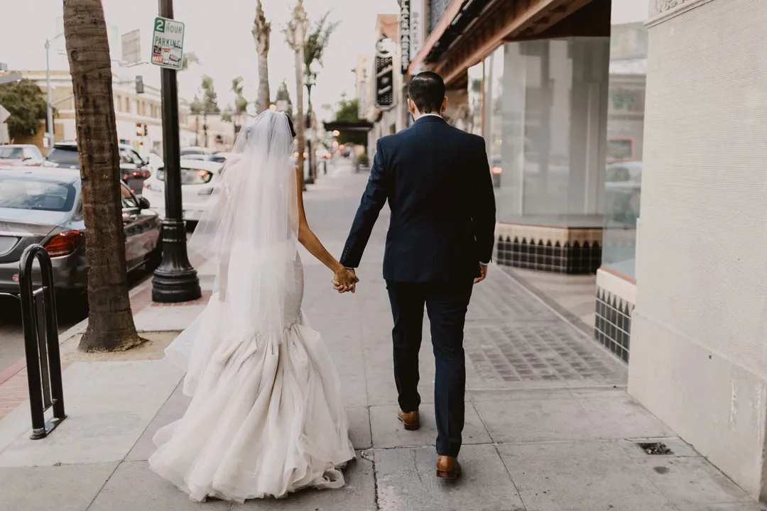 Newlyweds walking away hand in hand
