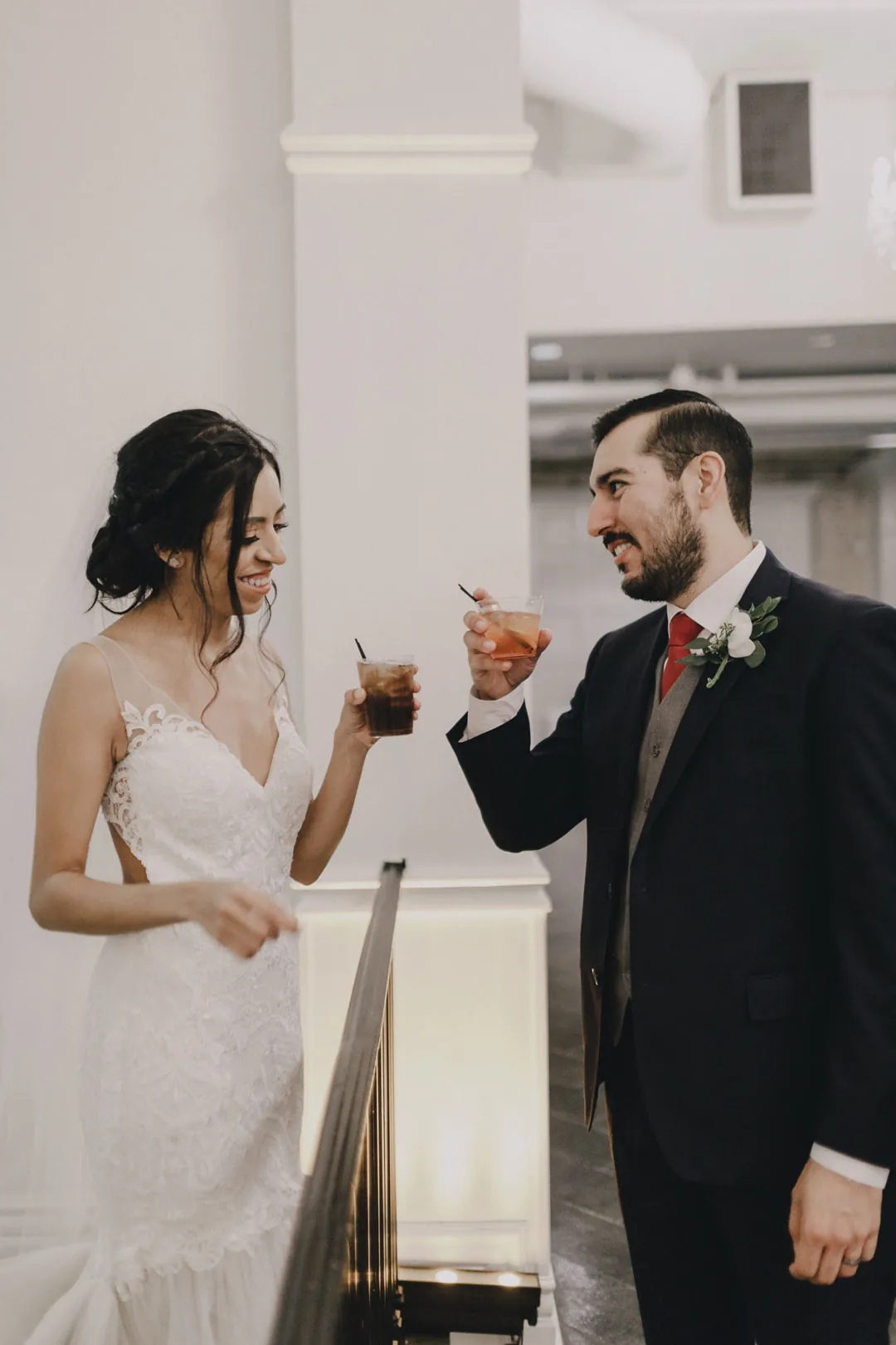 Bride and groom sharing a drink indoors