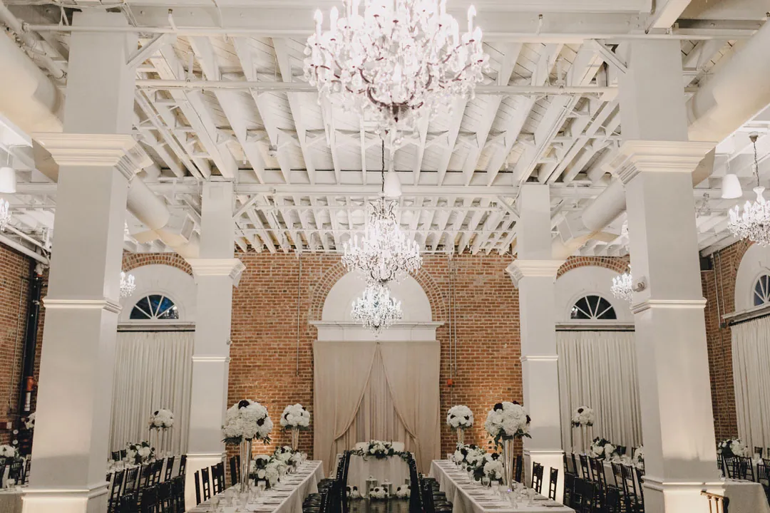 Chandeliers hanging above the decorated ballroom