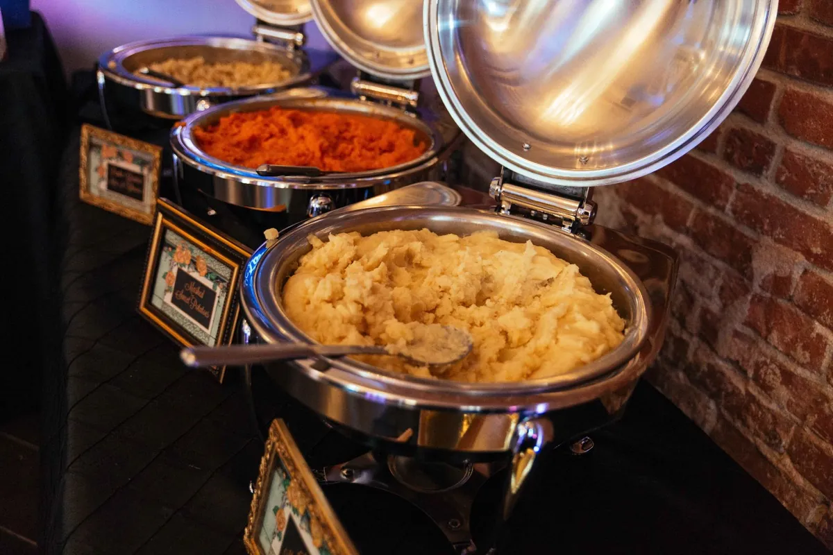 Open buffet pots filled with prepared food