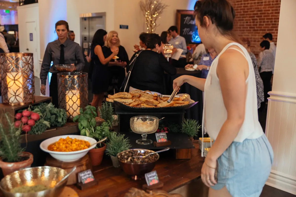 Guest selecting food from a buffet table