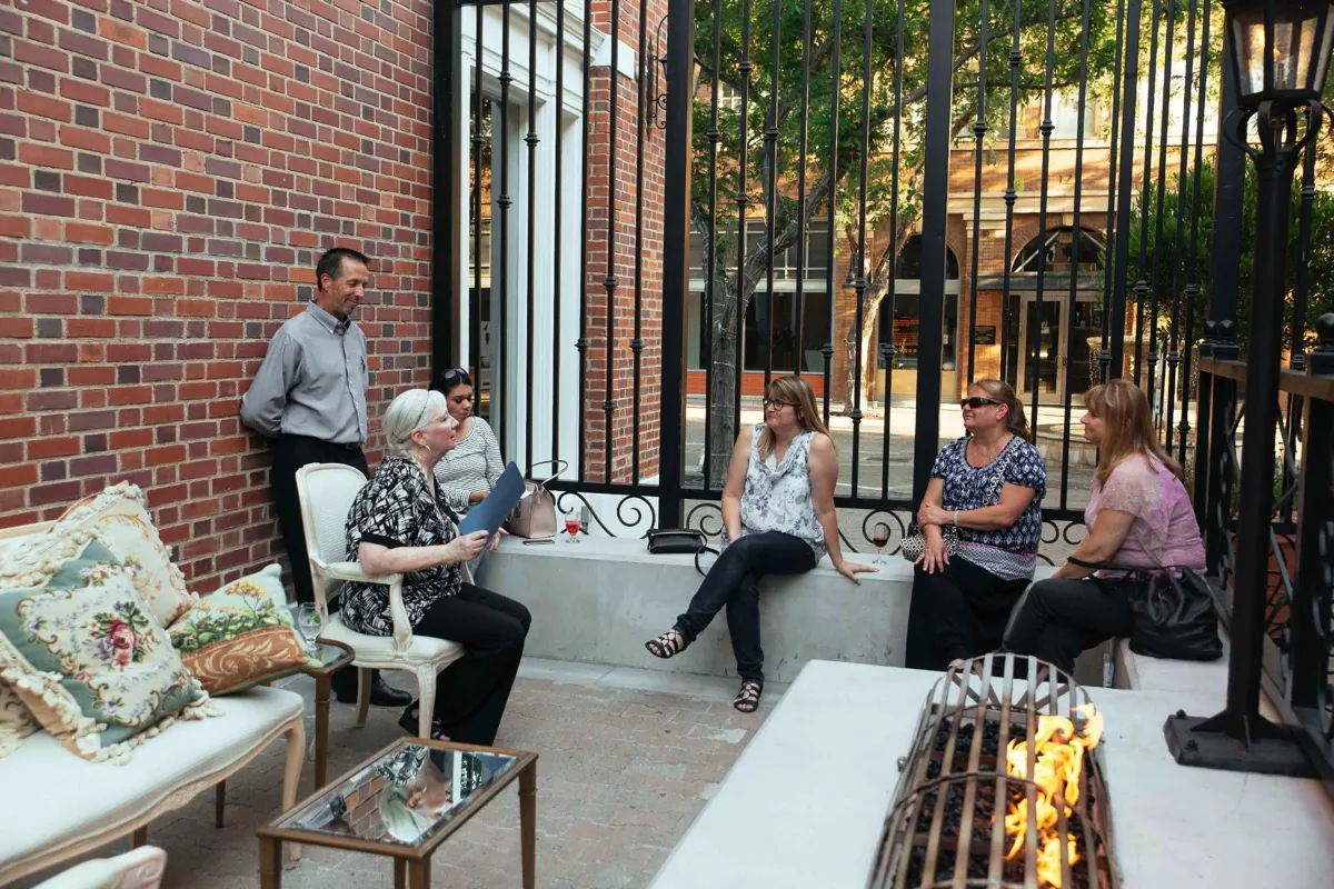 Guests relaxing on lounge seating in an outdoor courtyard