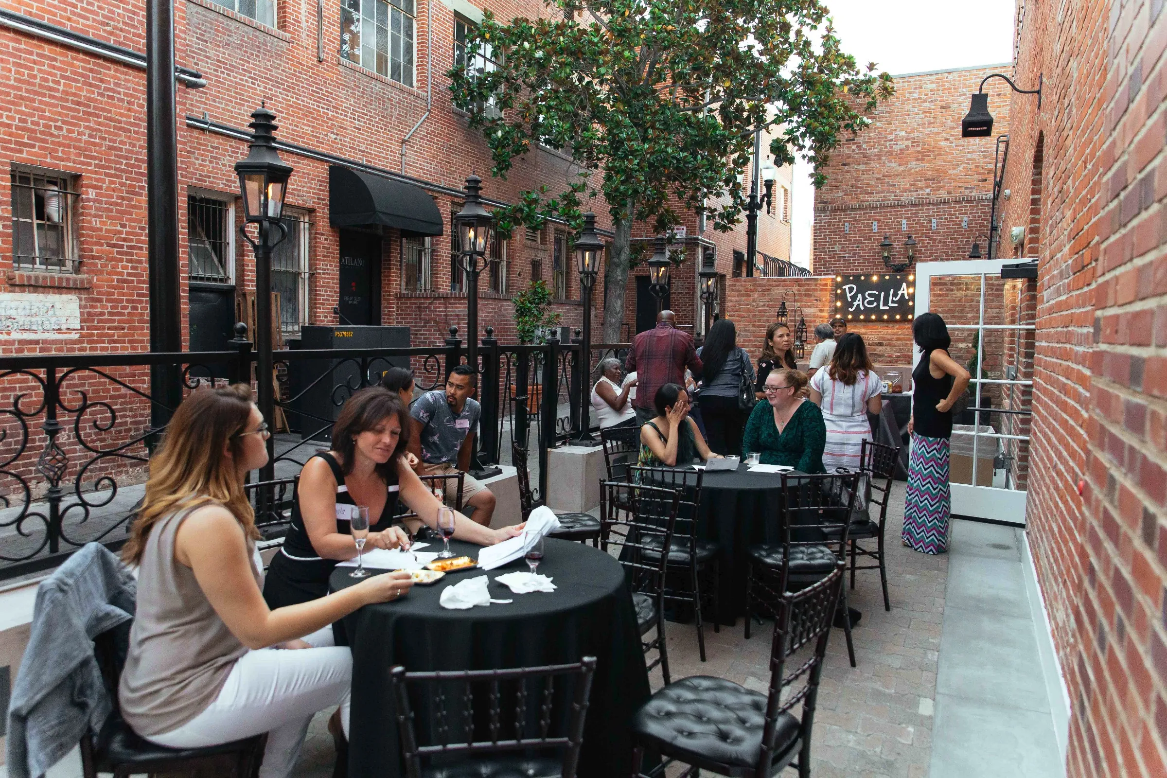 Guests dining along an outdoor courtyard passage