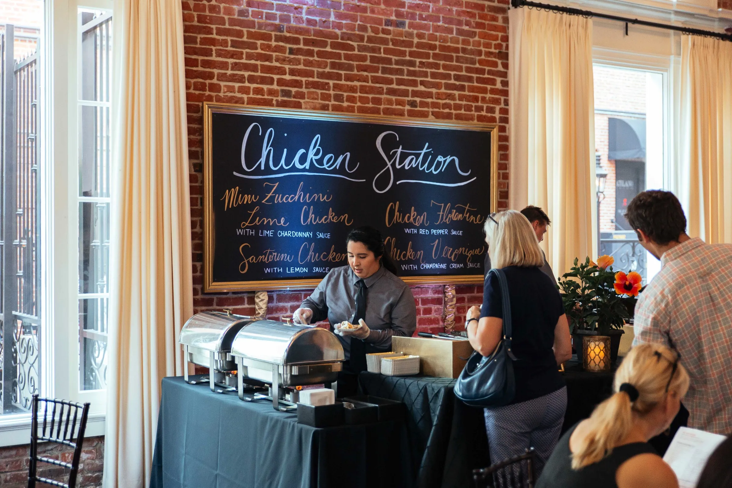 Guests choosing food at a chicken station