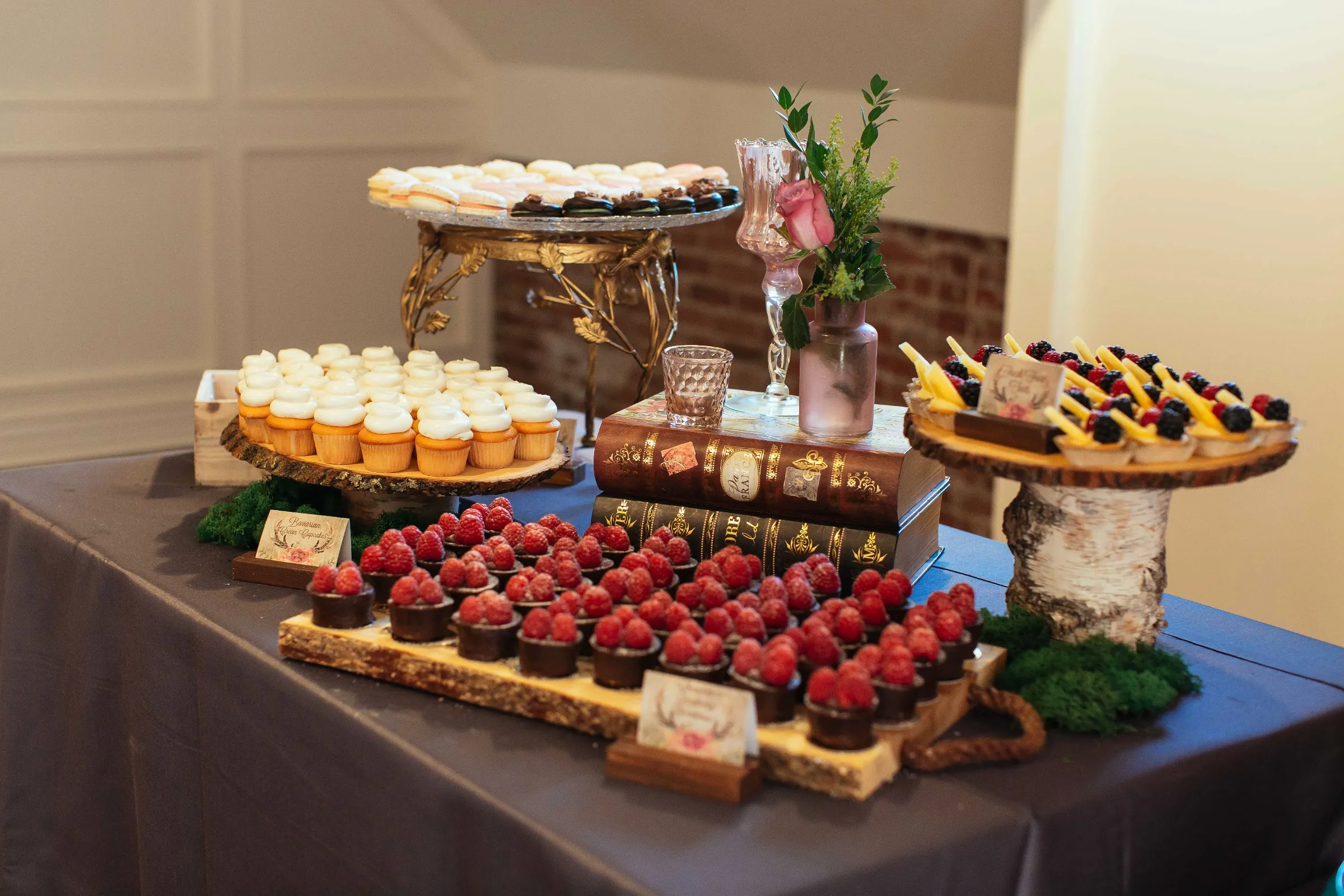 Assorted desserts and strawberries displayed on stands
