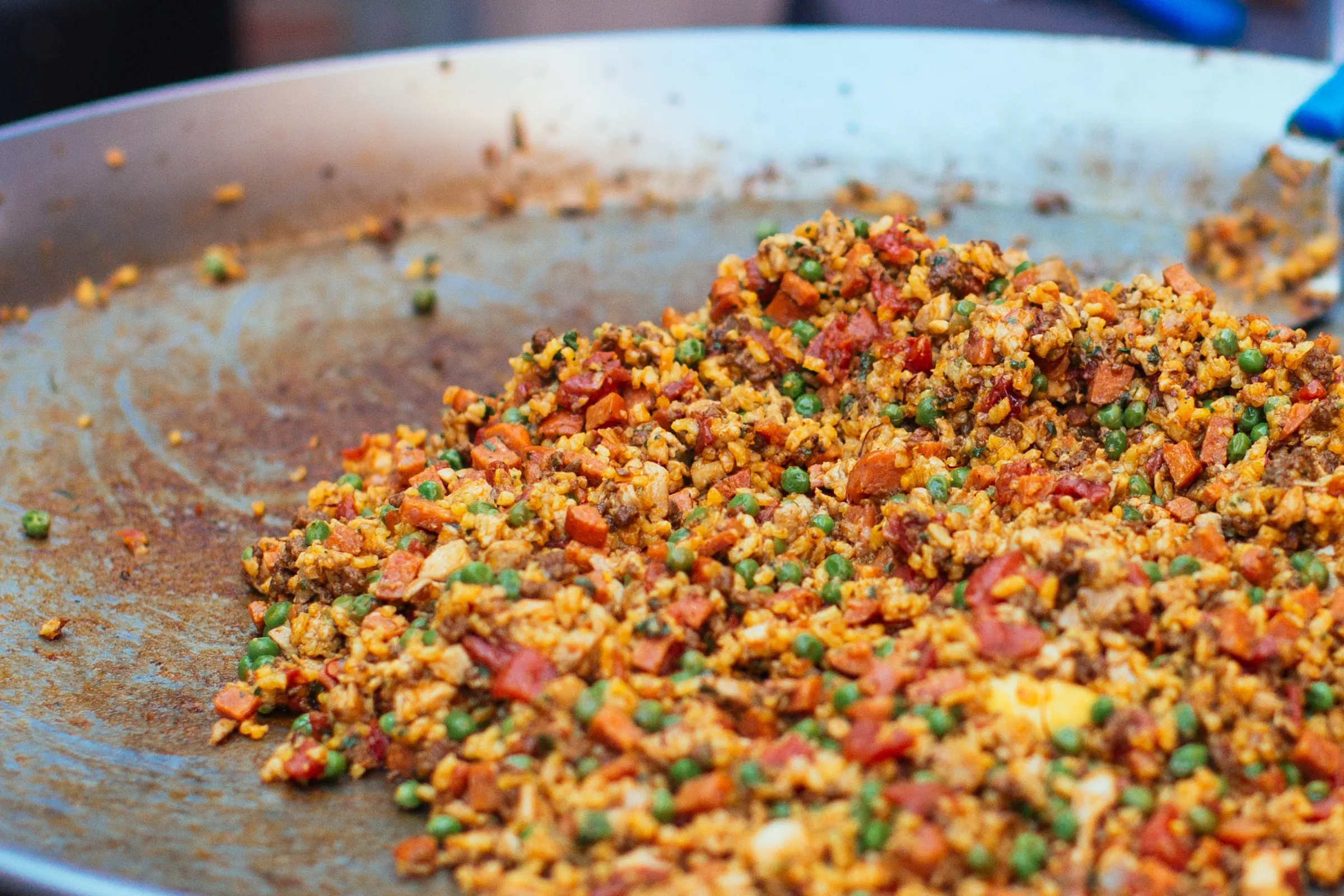 Mixed grains and vegetables cooking on a large griddle