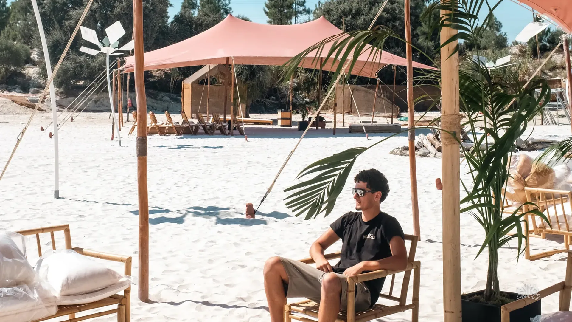 Beach lounge under a terracotta stretch tent
