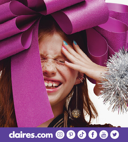 Young girl with large hair bow smiling with her eyes closed