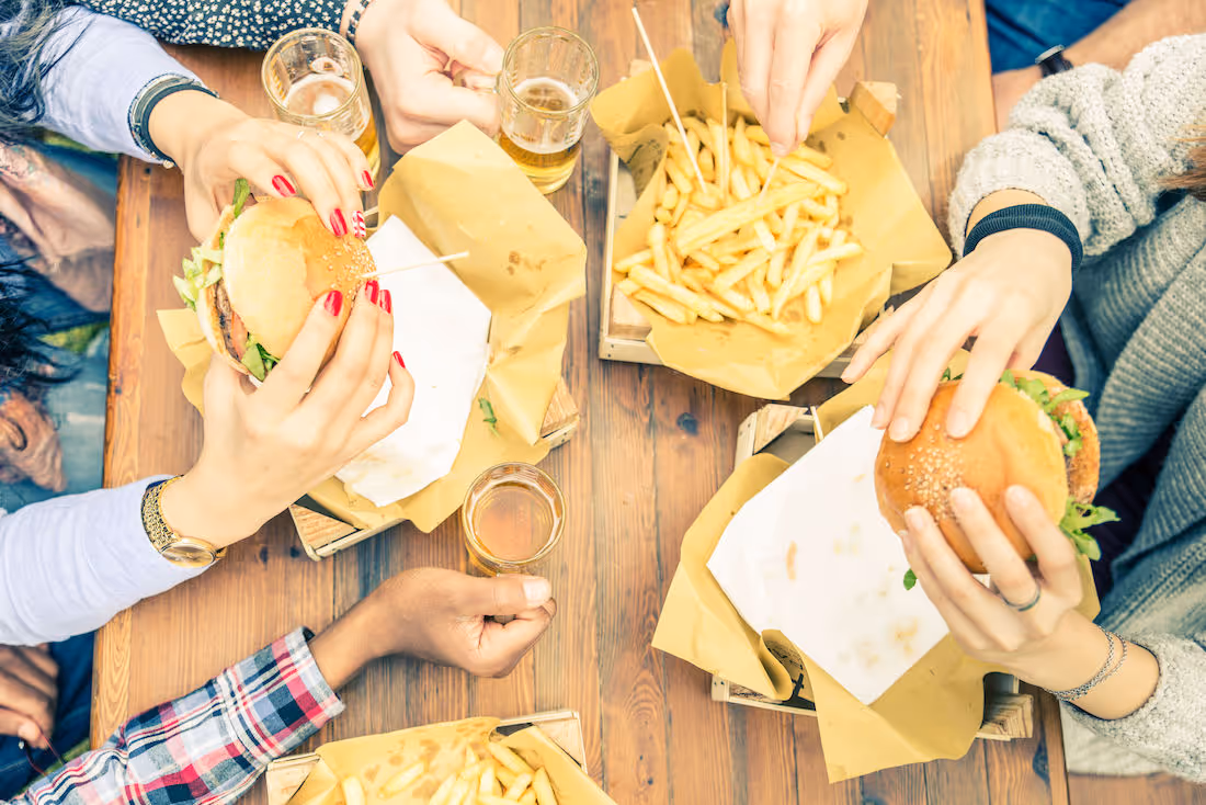 people eating burgers and fries
