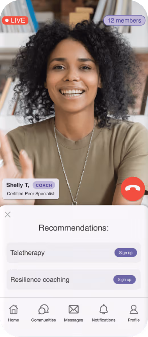 Smiling woman with curly hair live on video as a coach with options for teletherapy and resilience coaching.