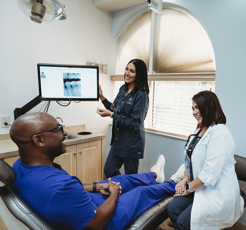 Photo of Dr. Pryszlak, a team member, and a patient