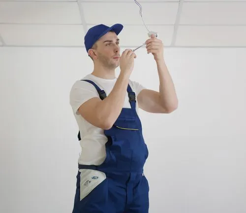 Electrician working on a light fixture