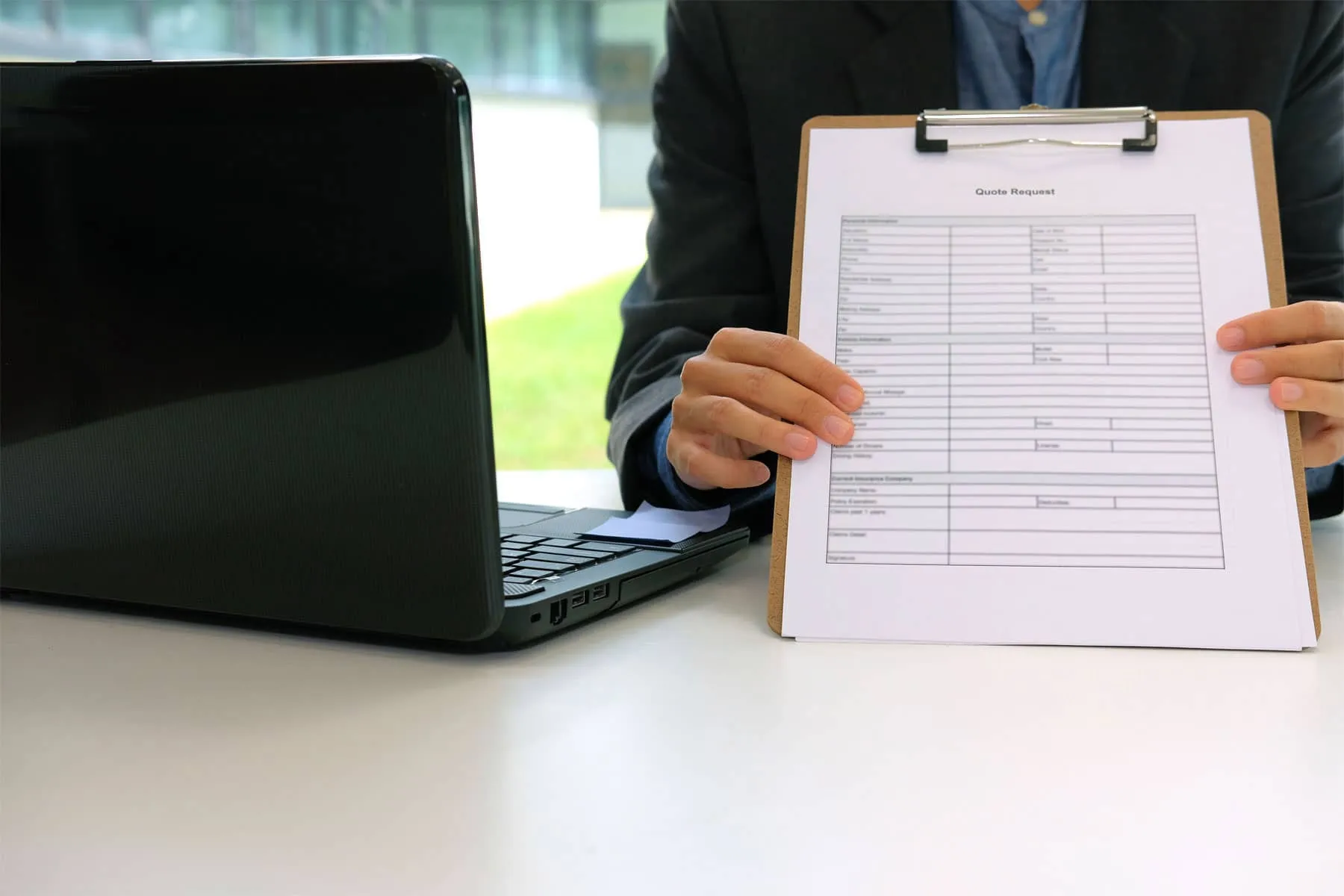 man holding a quote request form