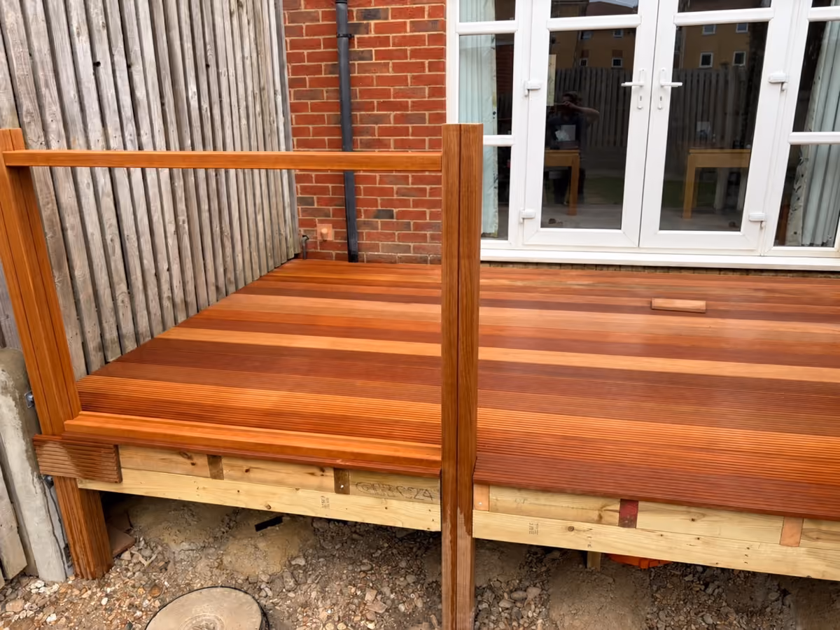 Left view of timber decking and wooden railing during construction, with exposed supporting framework
