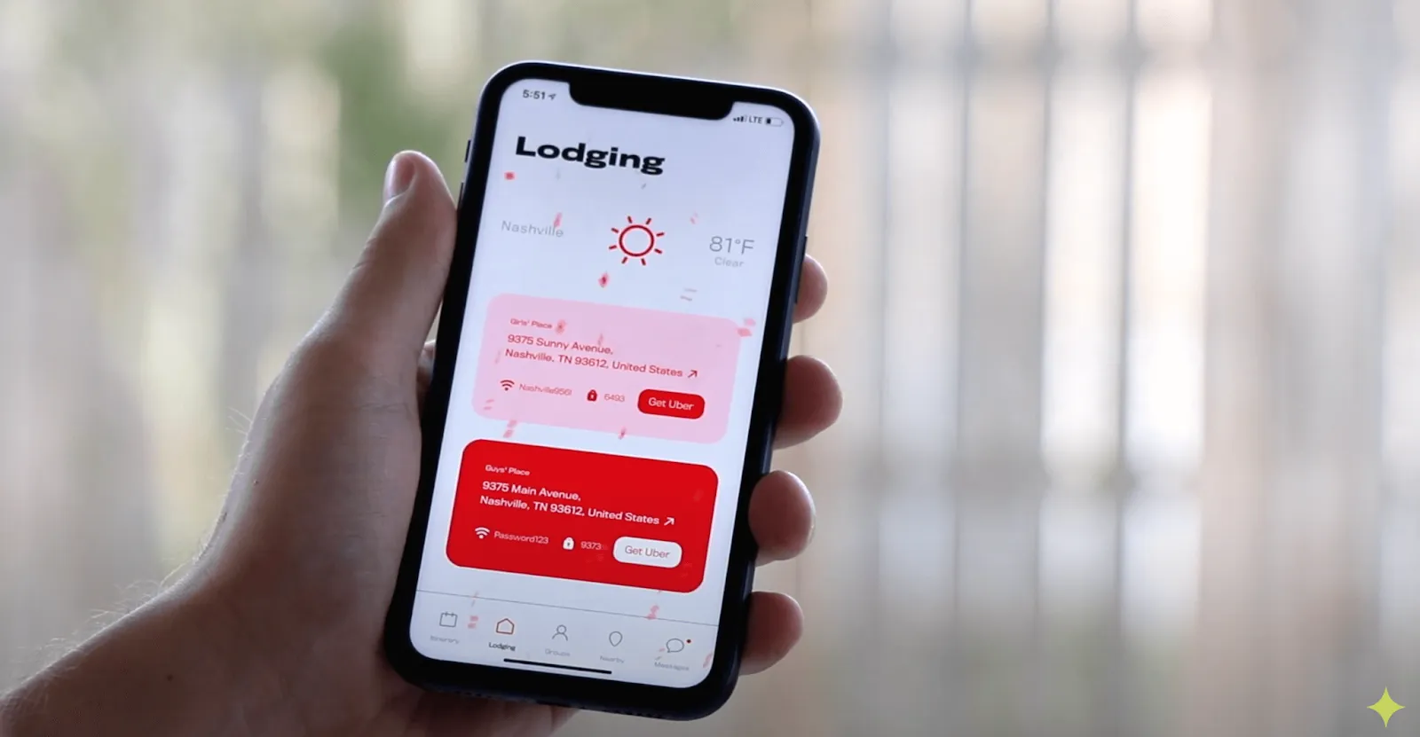 A hand holding a smart phone displaying a Lodging app